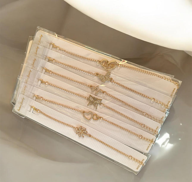 12 Pulseras Doradas con Dije $5.6 c/u