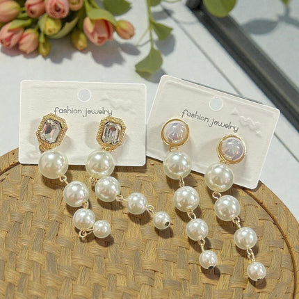 12 Aretes Perlas Colgantes con Pedreria $13.7 c/u