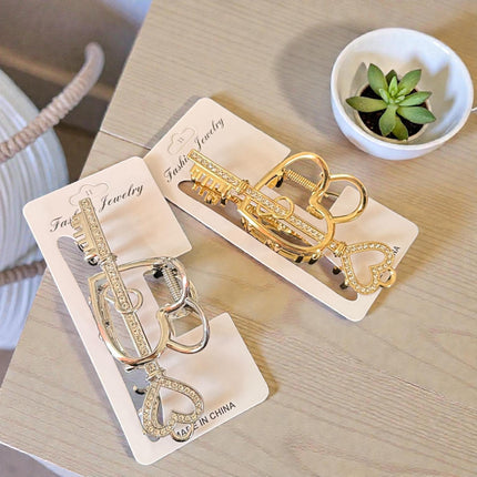 12 Pinzas para Cabello Doradas/Plateadas Corazón con Pedreria  $26 c/u