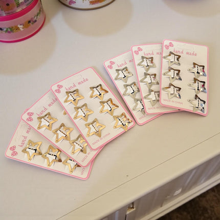 12 Sets de 6 Estrellas Cuquitas-Pasadores Doradas/Plateadas $9 c/u